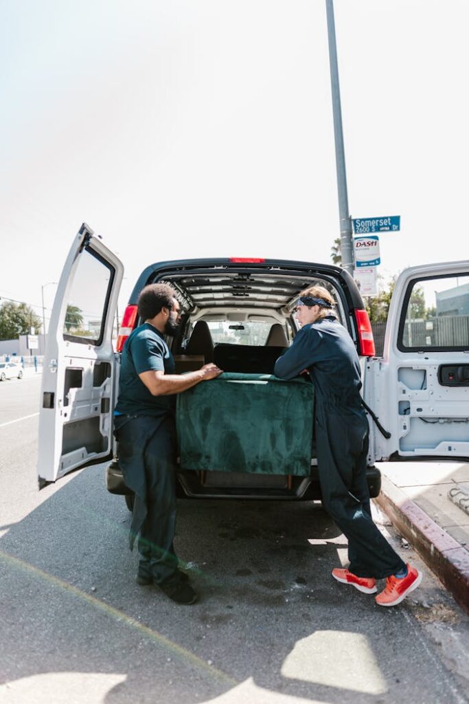 Man in Blue Long Sleeve Shirt Sitting on Green Car Seat